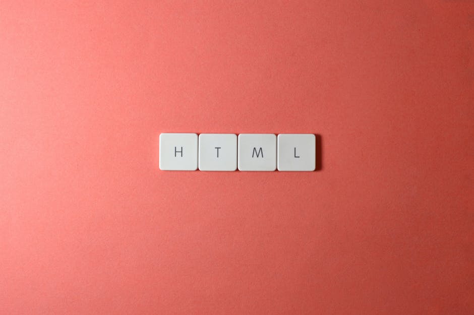 A close-up photograph of four white square tiles arranged in a horizontal line on a coral-pink background, each tile displaying a black letter spelling out 'HTML'. The tiles are clean and evenly space